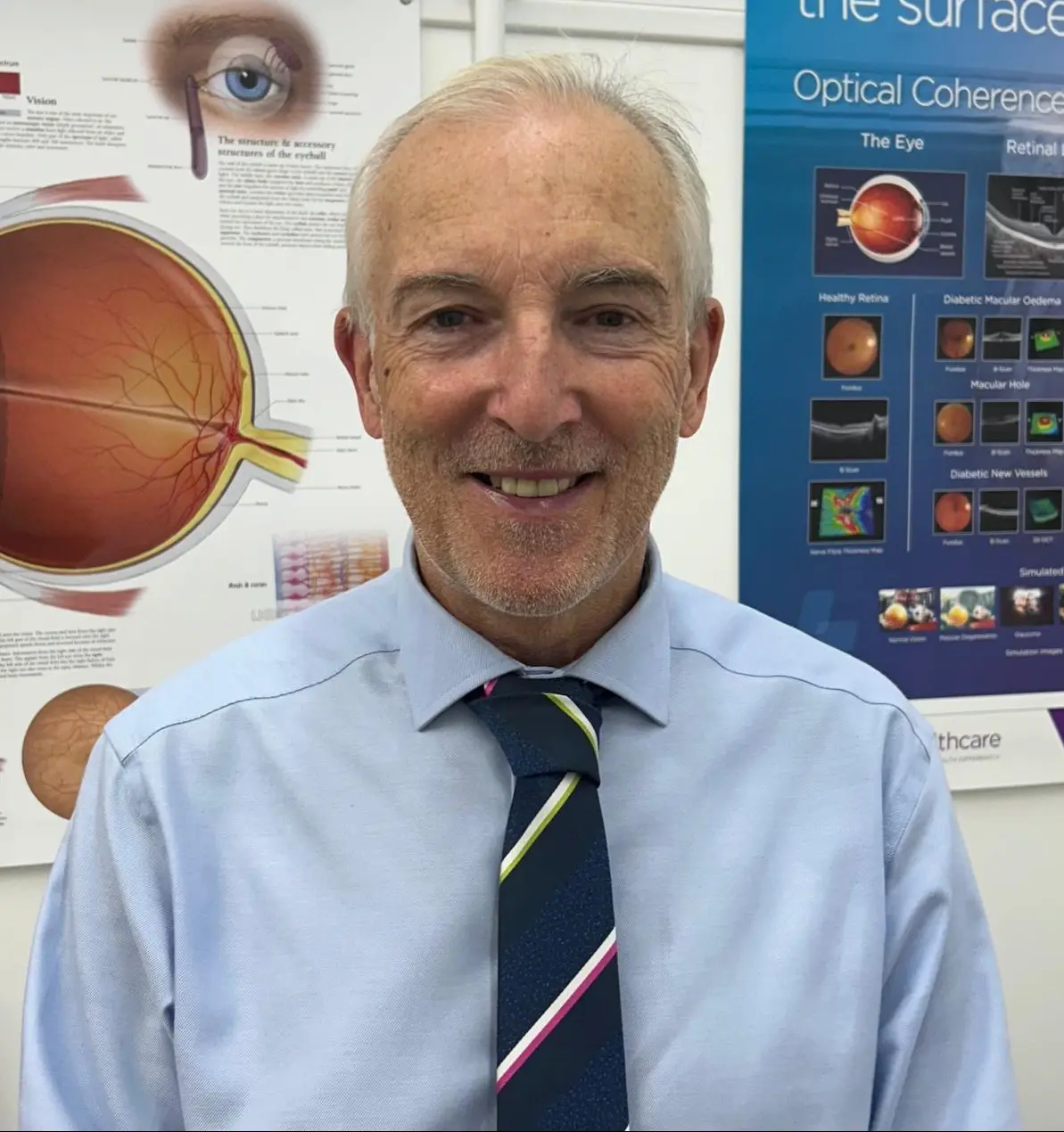 Kieron Johns, optometrist at Cwmfelin Opticians, in front of the OCT wall display